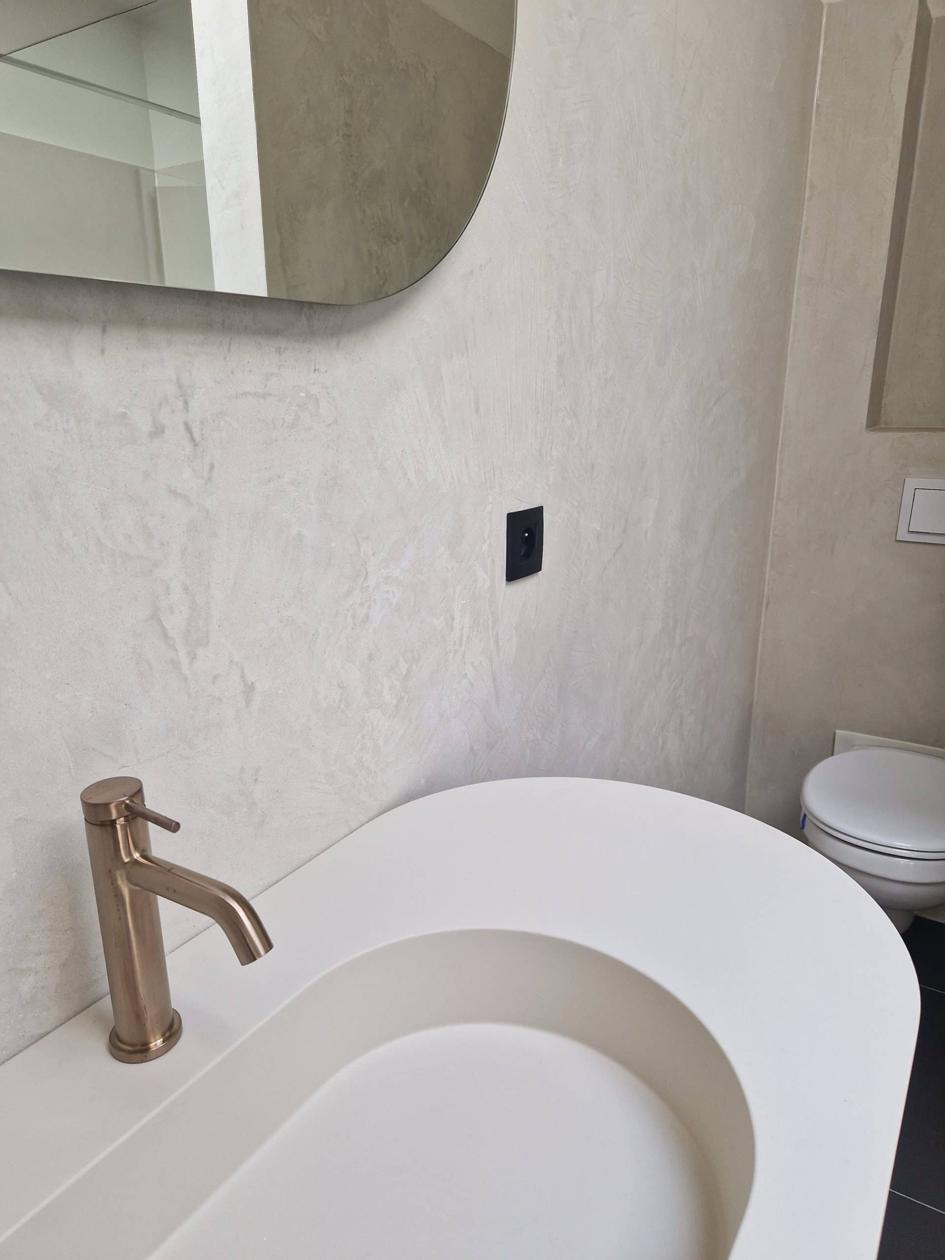 Salle de bain en Mortex beige clair sur sol et murs, vasque design et robinetterie cuivrée, réalisation Sol Color